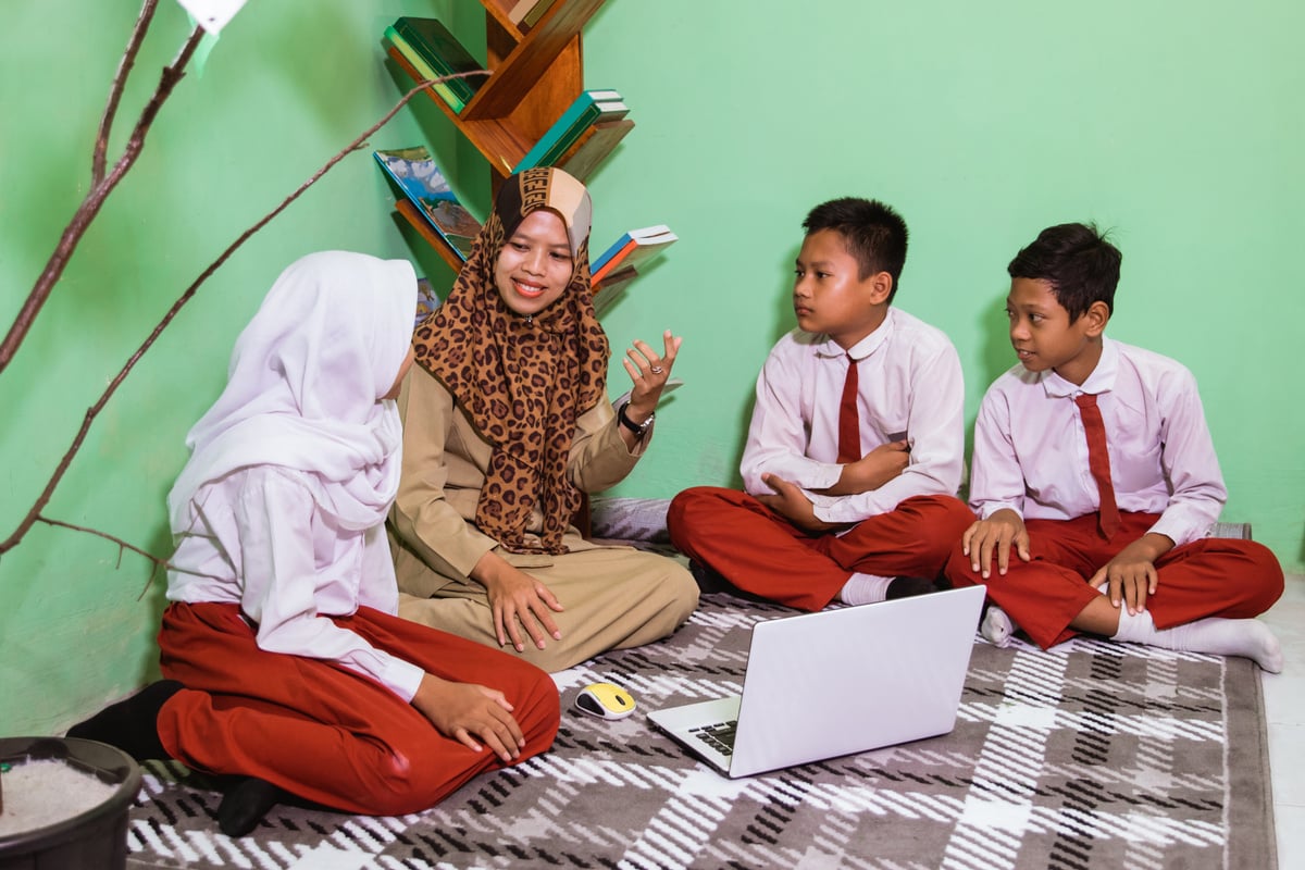 Indonesian School Students with Their Teacher Have a Discussion